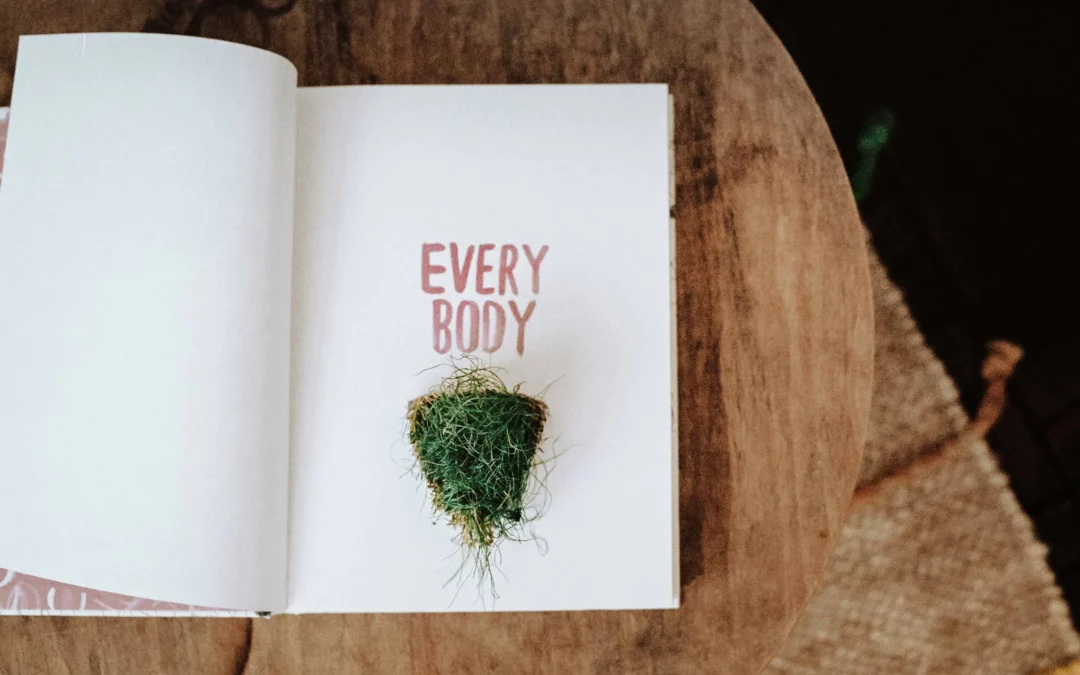 a book with the words every body and a triangle of grass in the middle of the page